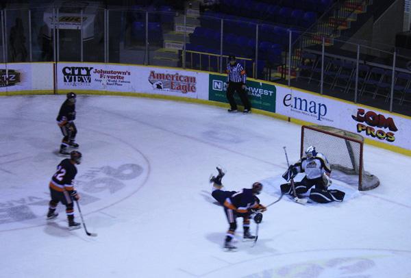 Hockey players check, glide, fire toward goals