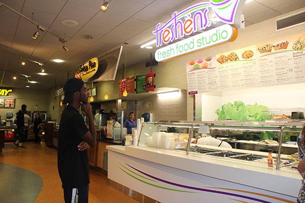 Pitt-Johnstown sophomore Rafiq Whitely peruses the extensive menu at freshens fresh food studio. 