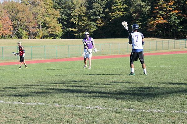 Two Pitt-Johnstown club lacrosse players play catch during the team’s first practice of the season last week.