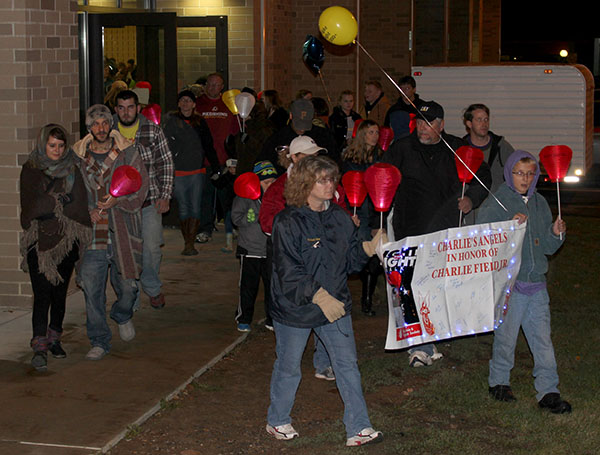 The Charlies Angel’s Team holds a banner and begins their walk around campus. 