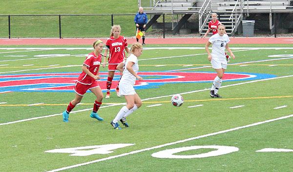 Pitt-Johnstown’s Katie Bucchin passes the ball to Emily Pennell in last Tuesday’s game against Davis & Elkins (W.Va) College. 