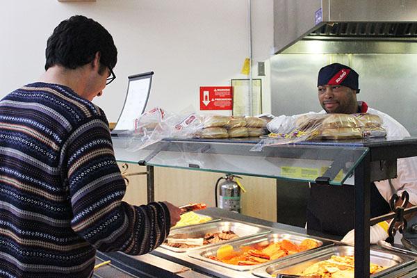 Sodexo employee Laurence Jackson interacting with student Jeffrey Adams at the Student Union Cafeteria.