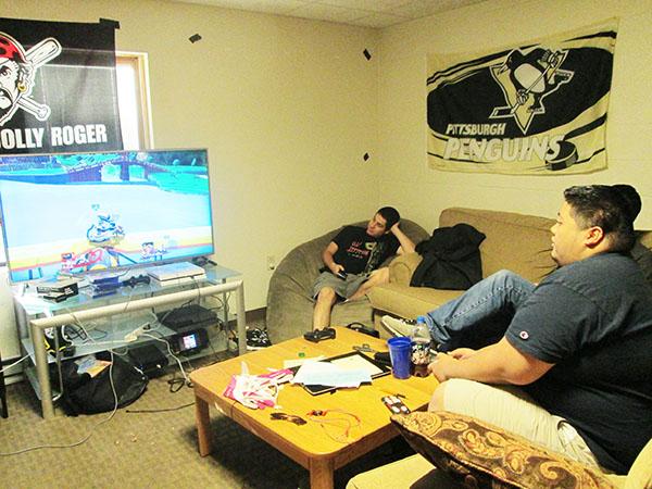 Jared Daskal watches Miguel Alisasis plays his friend at Super Smash Brothers in their townhouse Oct. 8.
