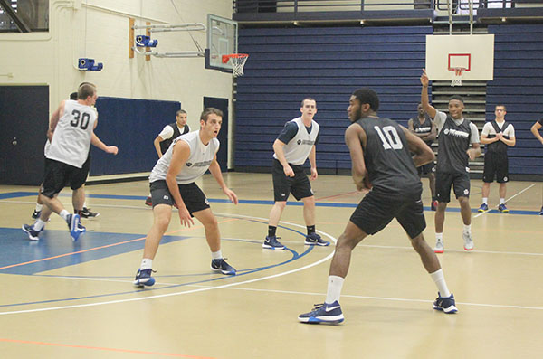 Junior guard Rasaun Mosley (right-center) runs a play during practice last week as sophomore guard Dale Clancy (right) looks for the ball, while current redshirt Romano Sebastiani (left) and junior guard Jake Lavrie defend the play.