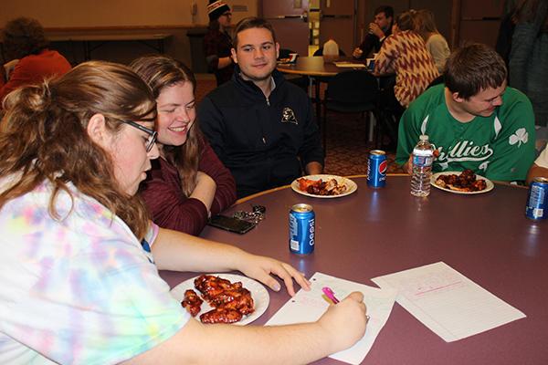 Left to right, freshmen Allura Rigoni, Kay Morris and Nick Clarke write down campus suggestions for student government members to think about at a brainstorm event.