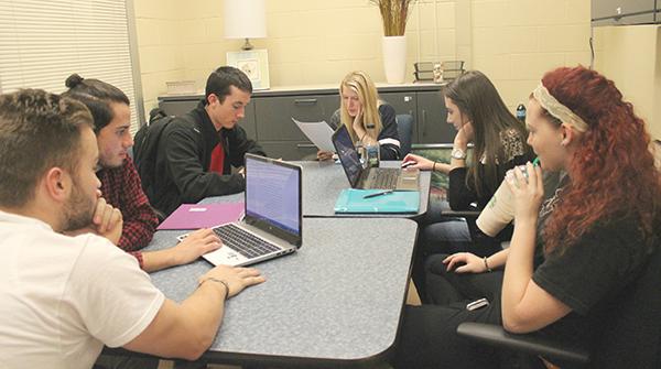 From left to right sit Vitto Marini, Jacob Williamson-Rea, Dylan Gumbel, Kristin Cafaro, Amanda Eckenrod and Alyshia Sechoka. Tutors Williamson-Rea, Cafaro and Sechoka assist students who attend a drop-in writing tutoring session in the Academic Success Center.