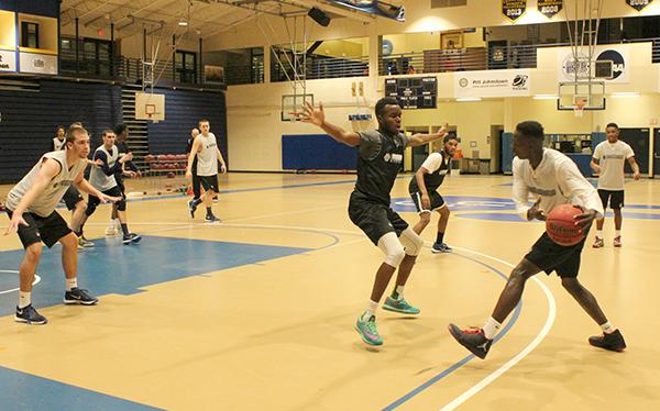 Sophomore forward Levi Masua (right center) plays defense on freshman teammate Olando King Jr. (far right) last week at practice in the Sports Center. 