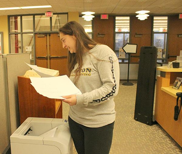 Pitt-Johnstown student Julie Salisbury prints off documents from a printer in the Owen Library. 