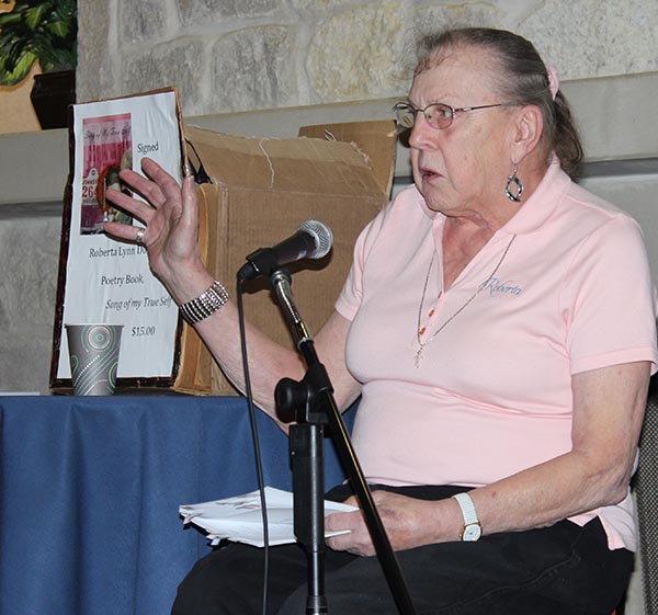 LearningPLUS student Roberta Dostal reads the audience poems from her book. 