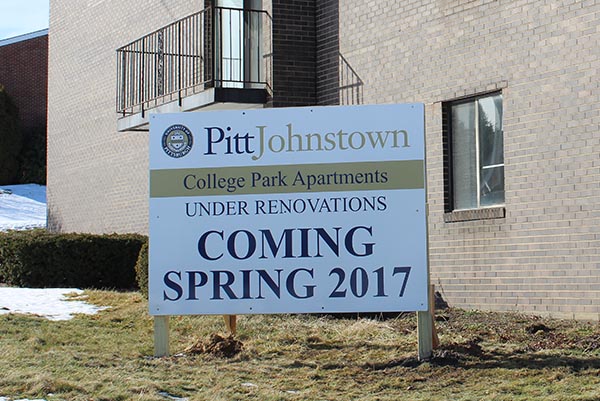 A newly placed sign in front of the College Park Apartments indicates upcoming renovation.