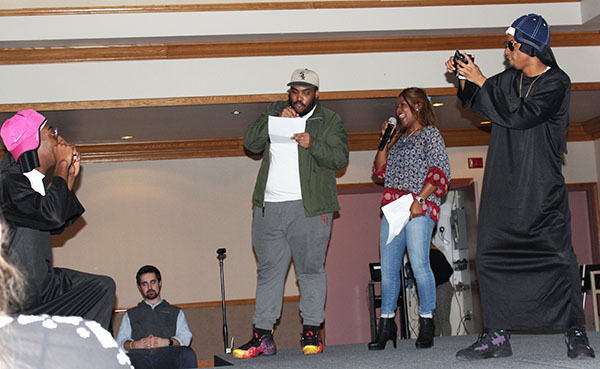 From left to right are sophomore Rafiq Whitley, junior Nico Fedusa, junior Taj Green, sophomore Dana Dyer and sophomore TJ Mitchell-Scott. Volunteer Mitchell-Scott photographs volunteer Whitley as announcers Green and Dyer read information about Mitchell-Scott and Whitley to the audience.