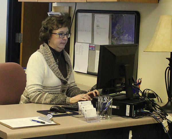 Employer relations specialist Kim Shook, a Career Services employee, types on a computer in the Career Services office. 