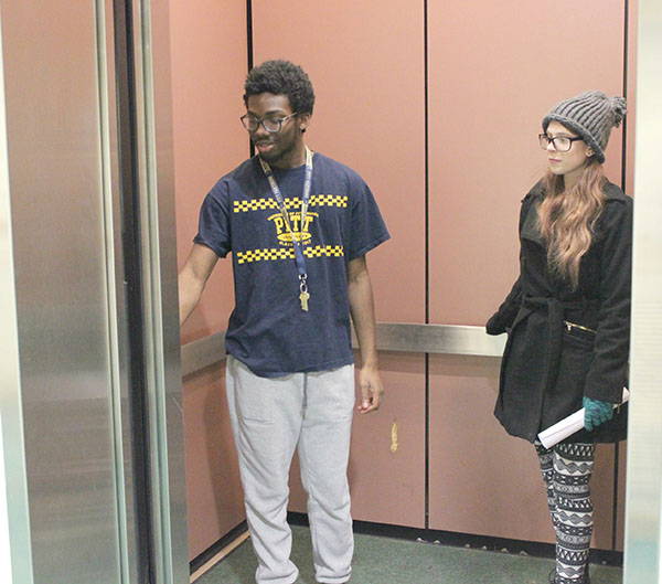 Sophomore Demar Watson (left) is in a Living/Learning Center’s elevator with Freshman Kiri McCoy.