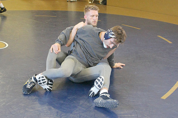 Sophomore Cody Law and redshirt sophomore Tyler Reinhart prep for nationals in the wrestling room last week at practice. 