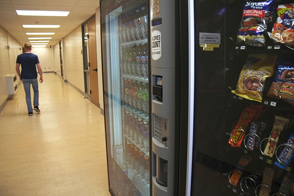 Freshman Nolan Pritts walks past a vending machine. 