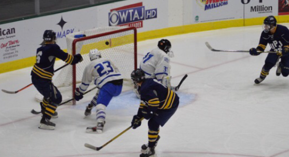 Forward Mark Swankler (right) scores a goal in the Icecats 6-5 victory Oct. 24 against Fredonia (N.Y.) State University at the Cambria County War Memorial Arena.