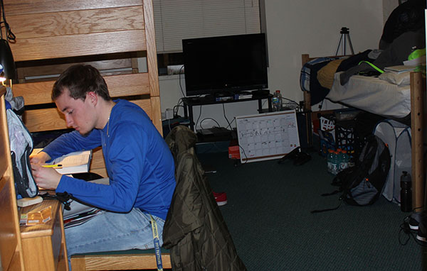 Sophomore Michael Leach studies at his desk in his Living/Learning Center dorm room. Leach lives with two roommates. 