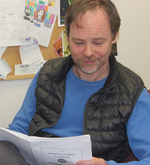 Ola Johansson checks students’ tests in his office.
