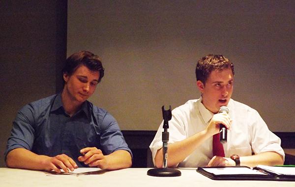 Vice presidential candidate Matt Christina sits next to presidential candidate Kevin McCormick during a debate.