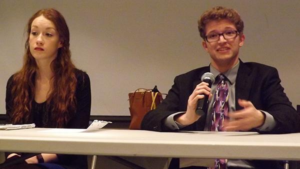 Vice presidential candidate Casey Ansbro sits next to presidential candidate Samuel Miller during a debate.