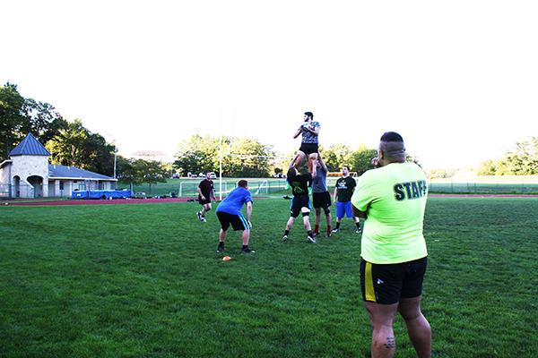 Head Coach Josh Horner runs through rugby drills with his team during practice Thursday, preparing them for their match against Saint Vincent College Sept. 23.
