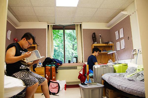 Freshmen Weijia Zhang (left) and Yihong Wang study in their Maple Hall room.