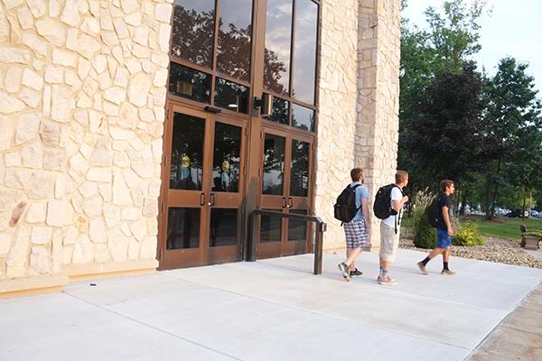 Sophomores Tony Pavia (left), Lucas Fetters (middle) and Dominic Grasso leave Blackington Hall after finding the doors locked at about 7 p.m. Sept. 17.