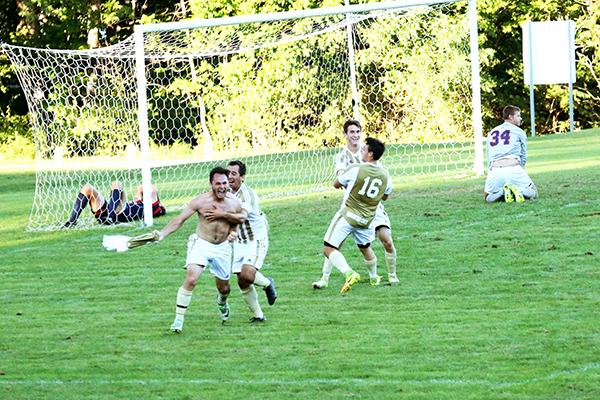 Sophomores Colin Michalski and Haven Mackie celebrate a game-winning goal with junior Colton Myers (16) and senior A.J. McNary against Shippensburg University the team went into double overtime for the victory.