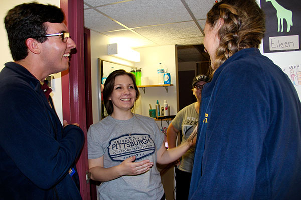 Resident Assistants Jeffrey Adams (left) and Kelly Bisceglia (right) joke with freshman Eileen Schmidt.