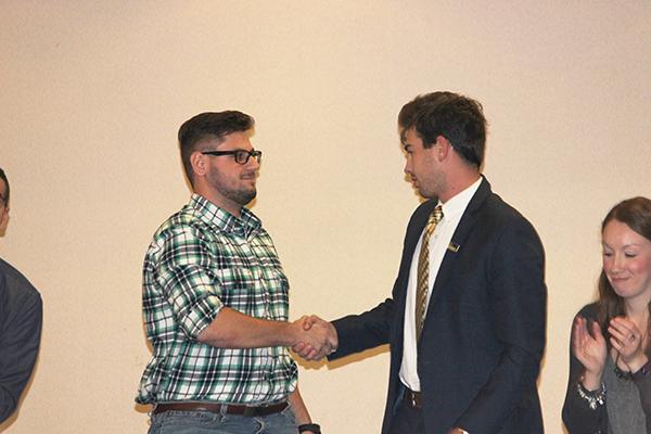 Senior Nick DiGiorgio (left) shakes Student Government Association President Kyle Maguire’s hand after stepping down as vice president.