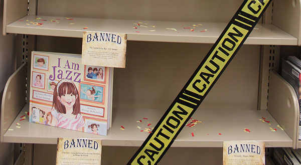 A shelf in the library is used to display some banned books.