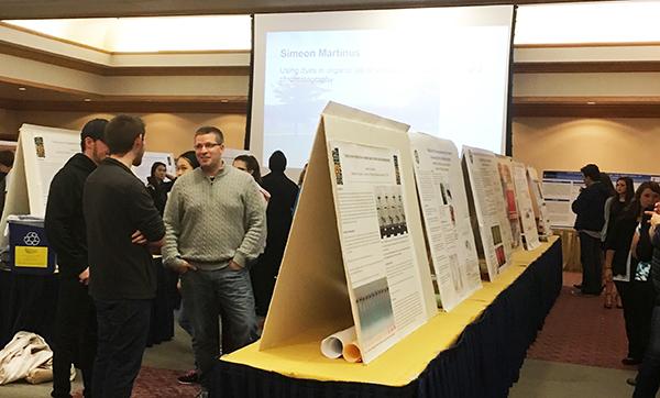 Guests tour the Cambria Room to view student and faculty research on display at the Fall into Research fair.