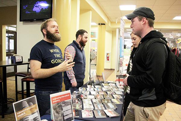 Freshman Kayla Soltis and Senior Nate Larson speak to International program representatives at a table last week.