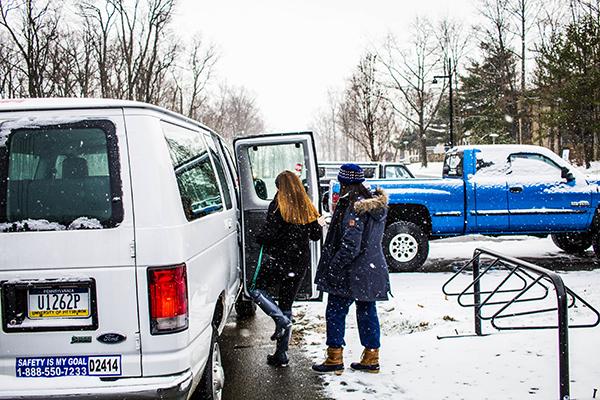 Two students board the campus shuttle outside the Student Union that travels to Richland Town Centre every day from 2 to 6 p.m. 