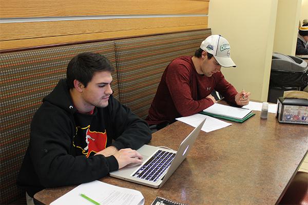 Senior Kevin Synan and junior Cole Benson prepapre for final exams by studying in a nook in the Student Union. 