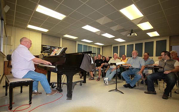 Samuel Louis Coco, Johnstown Symphony Chorus conductor, rehearses with singers. 
