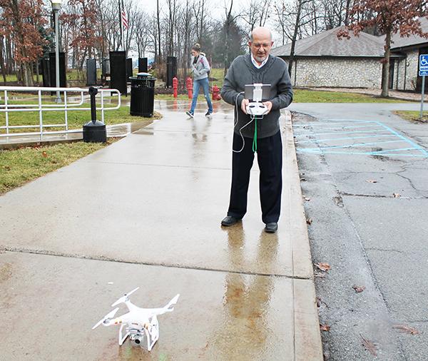 Geography professor Ahmad Massasati prepares to launch his drone Friday. Massasati and students in the Geography Department use the drones to take aerial photos of campus. 