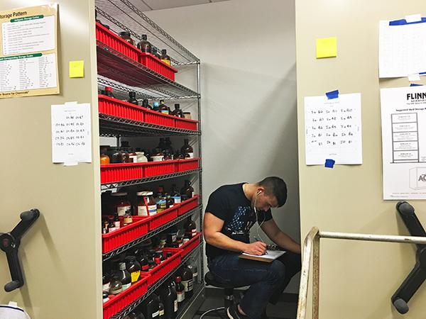 Senior biochemistry major Brandon Cook checks the Chemistry Department’s inventory of chemicals in 266 Engineering and Science Building room. 