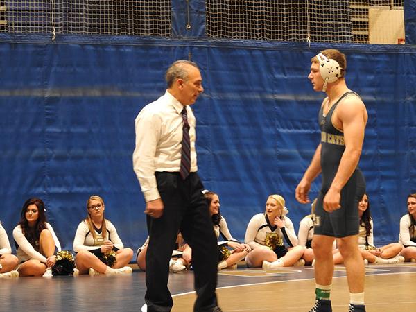 Pitt-Johnstown wrestling coach Pat Pecora talks to wrestler John Blankenship during a brief intermission.