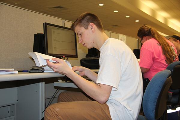 Sophomore Caleb Smith uses an Owen Library computer to review class notes.
