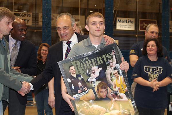 Senior wrestler Nick Roberts is congratulated as wrestlers were honered for their accomplishments Feb. 7 .