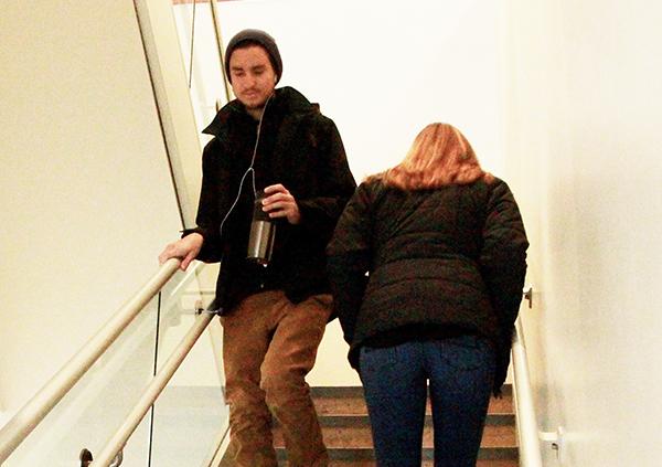 Senior Nick Dinofrio brushes shoulders with junior Niki Kusy as they pass each other on the Blackington Hall staircase. 
