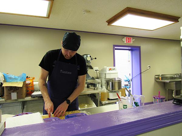 Chad Lamb, owner of the bakery Lambcakes, prepares baked goods before his store’s opening Feb. 28.  