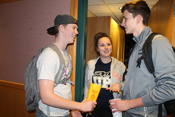 Freshmen Delta Chi brothers Justin Gunsallis and Tyler Murray collect money from sophomore Megan Gamber.
