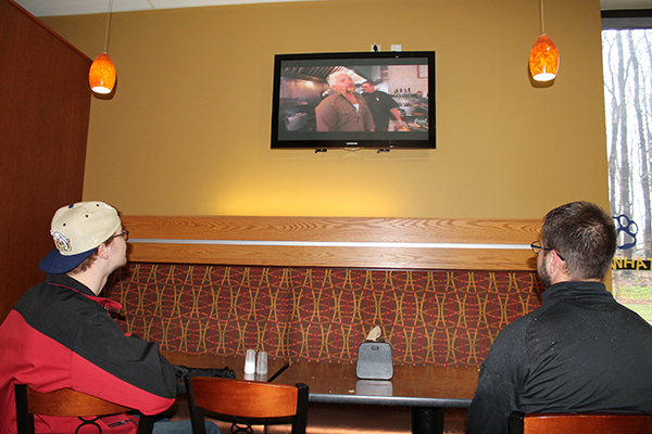 Freshman Allen Griffith and junior Mike Kawka watch the television in the Student Union.
