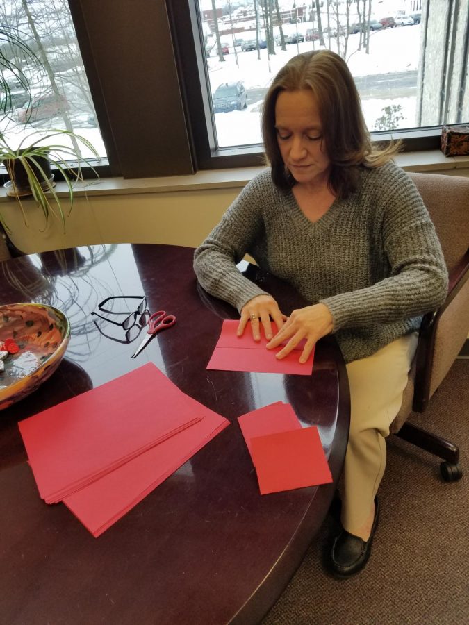 Assistant Academic Affairs Vice President Kristen Majocha makes red pockets with change in them Friday for Chinese New Year. 