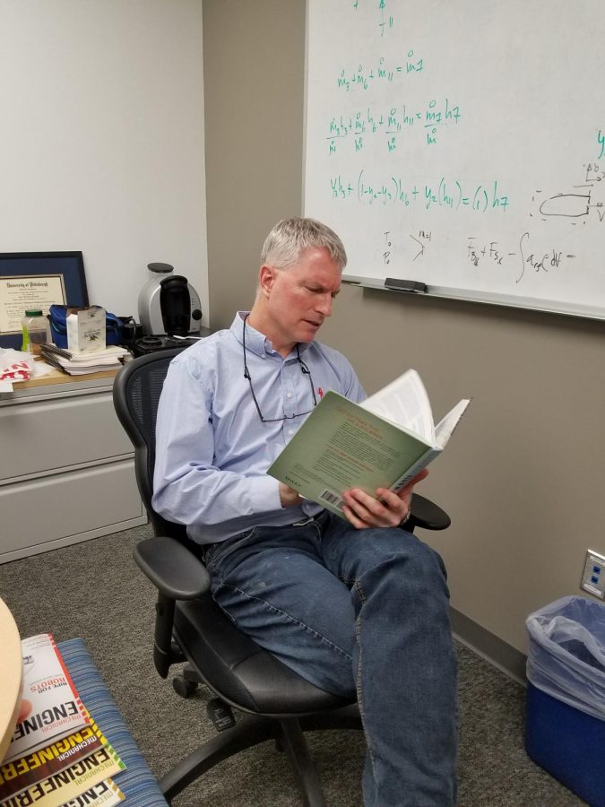 Mechanical engineering professor Kurt Klavuhn reads a fluid mechanics book. He leads the fluids review session for the Funamentals of Enigneering Exam this year. 