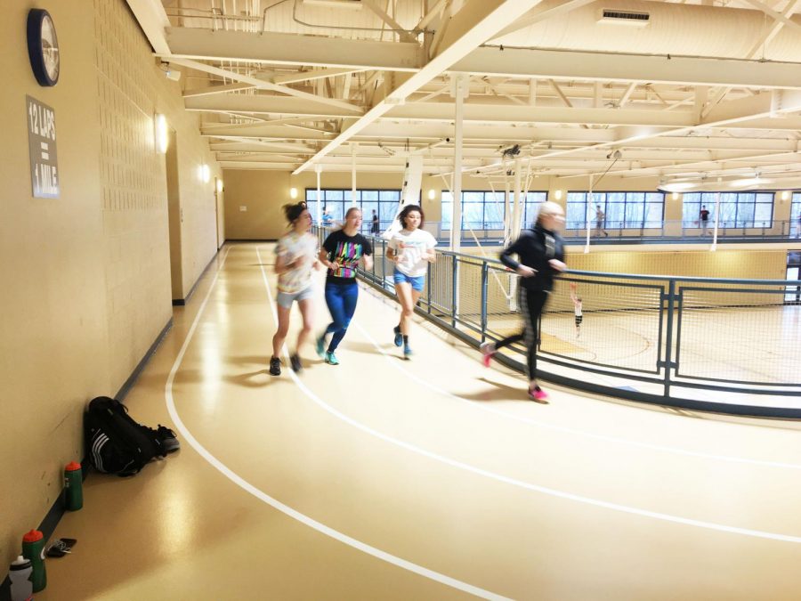 Track team members (left to right) Samantha Klutz, Alana Thomas, Taylor Briscoe and Samantha Miller run laps around the track in the Wellness Center last Friday.