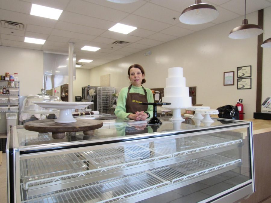 Kim Asonevich poses with a cake in her soon-to-open bakery, $2.49 Bake Shoppe. The Scalp Avenue bakery is to be open three days a week until May. 