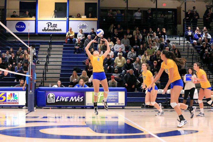 Sophomore J.C. Longeville (center, No. 2) sets the ball up for her teammates at the Sports Center during the conference quarterfinals last season. 